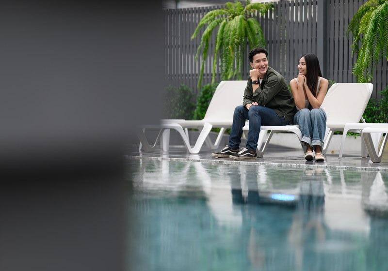 Guests relaxing beside the Infinity Pool at Wang Kaew Hotel